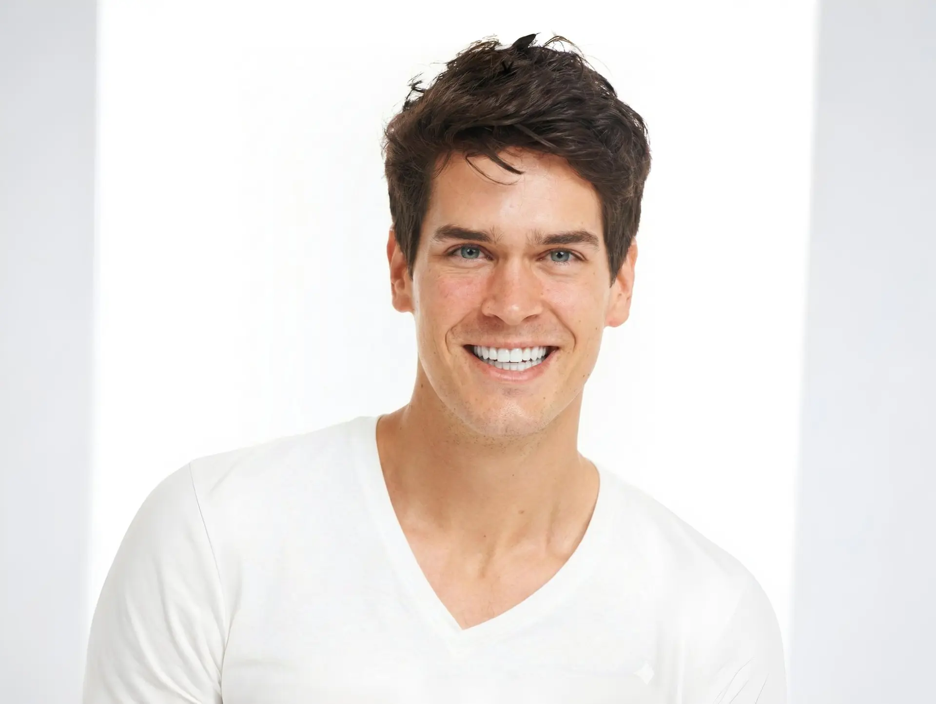 A young man with a healthy, confident smile